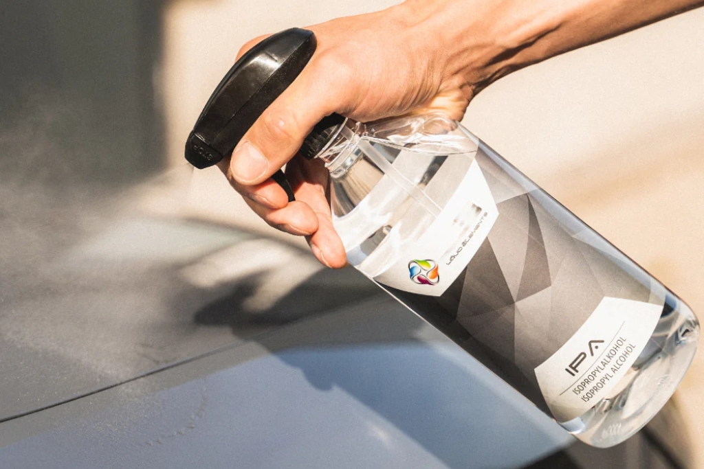 Test for Coating Removal — close-up of a hand spraying isopropyl alcohol on a car panel to check for remaining ceramic coating in Southampton, PA