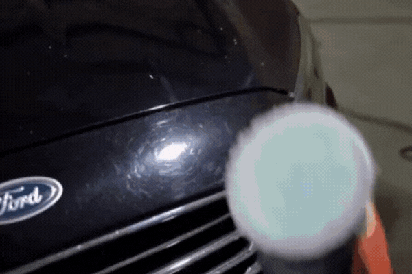 Seek Professional Help — close-up of a machine polisher being applied to the hood of a dark Ford vehicle in Southampton, PA during professional ceramic coating removal