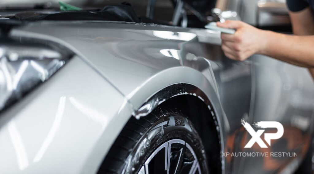 Paint protection film installation on car fender by XP Automotive Restyling in Southampton PA for advanced automotive paint protection