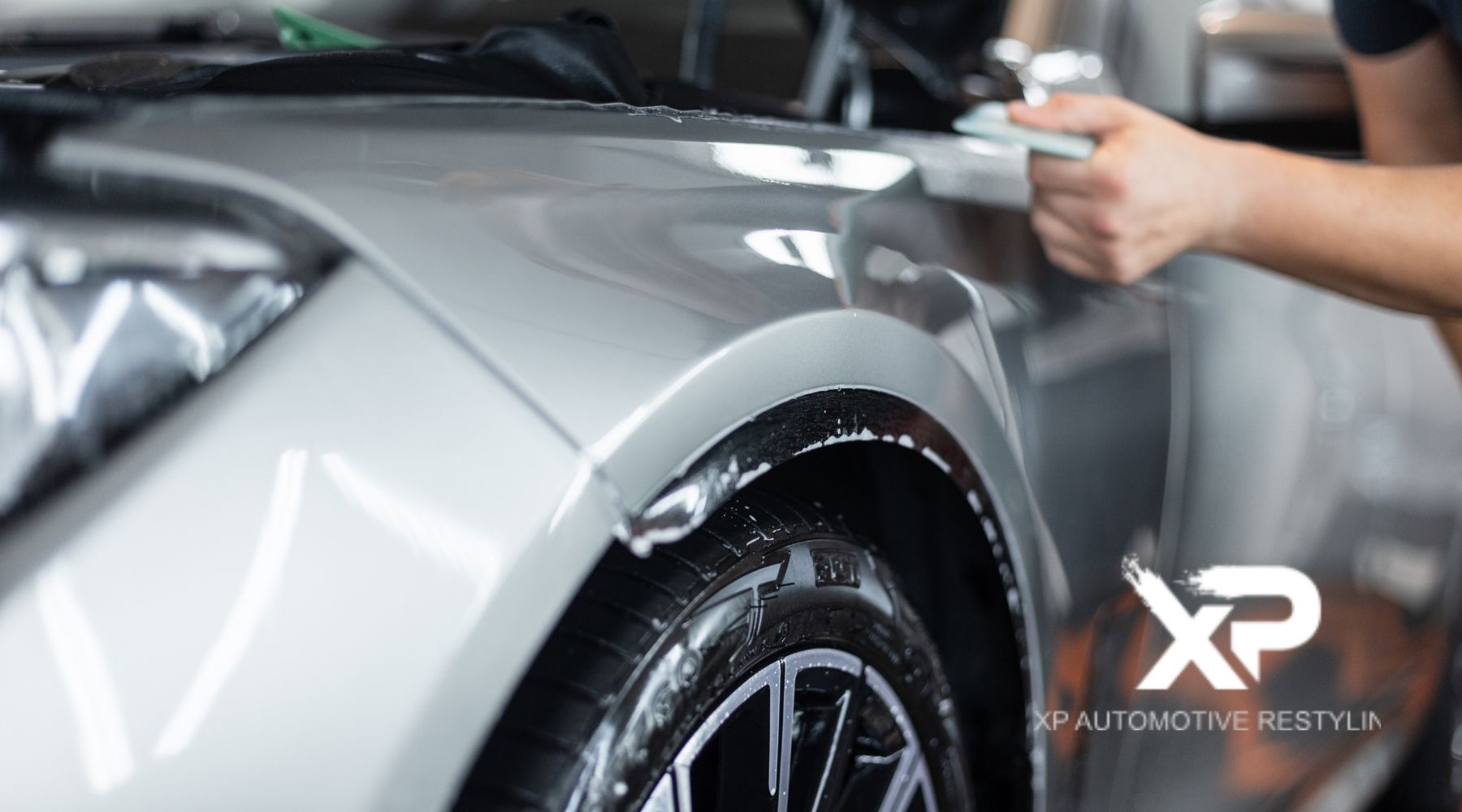 Paint protection film installation on car fender by XP Automotive Restyling in Southampton PA for advanced automotive paint protection